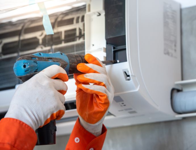 Technician installing an air conditioner