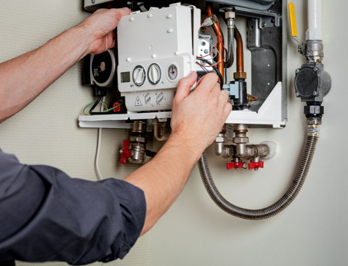 Technician servicing a boiler
