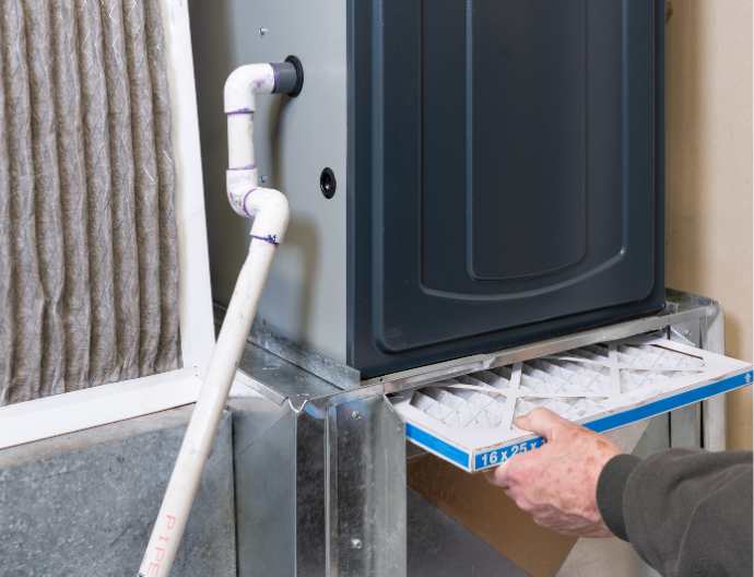 Technician servicing a home furnace
