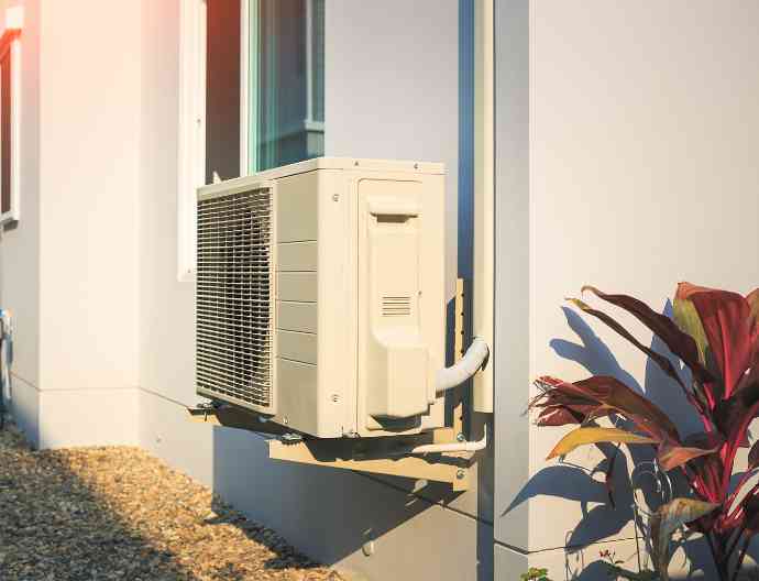 Outdoor air conditioning unit installed beside a home